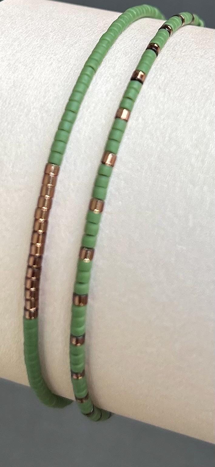 Handmade green and bronze glass seed bead bracelets on display, Seed and Soul artistry jewelry