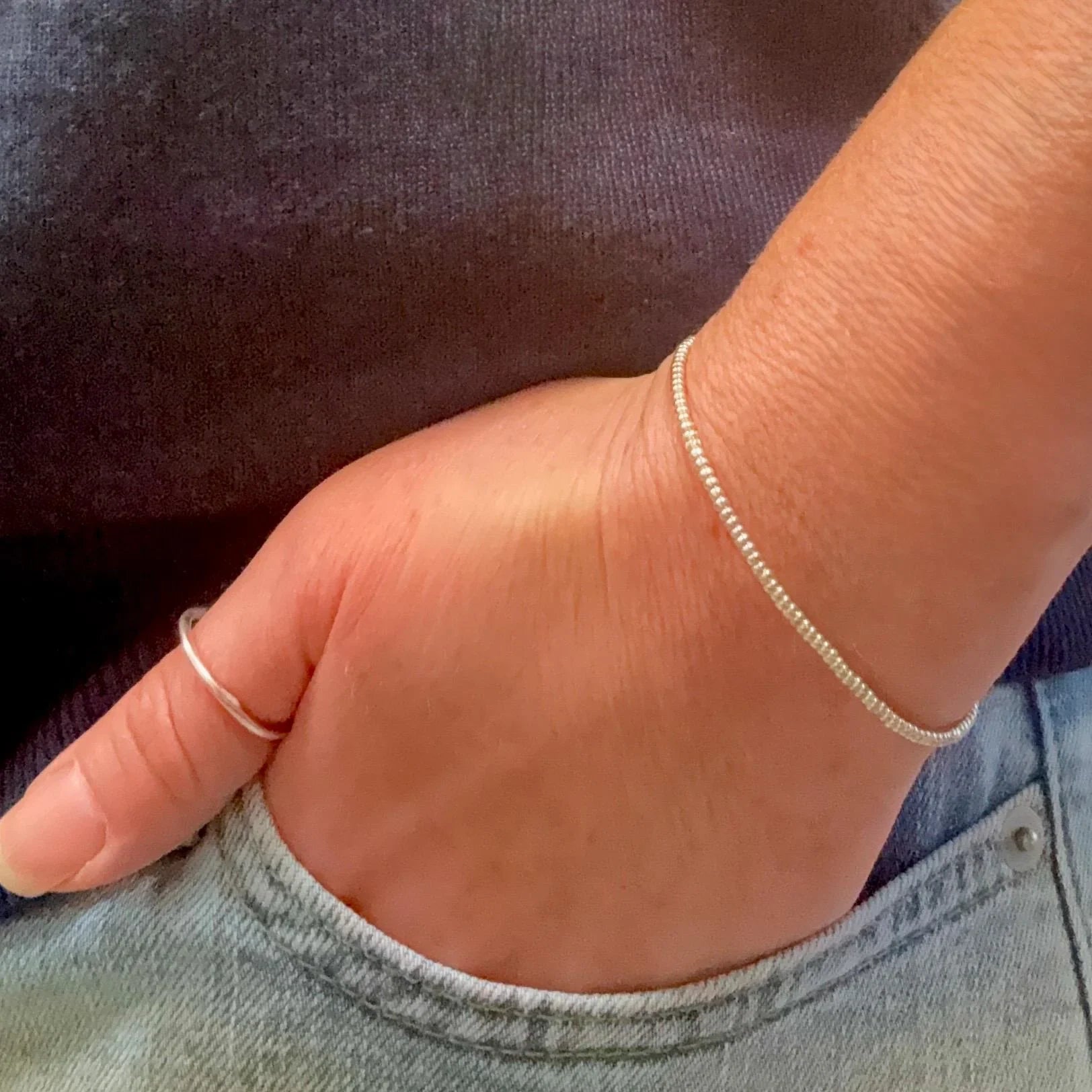Hand wearing a silver Miyuki seed bead bracelet and silver ring, Seed and Soul artistry jewelry