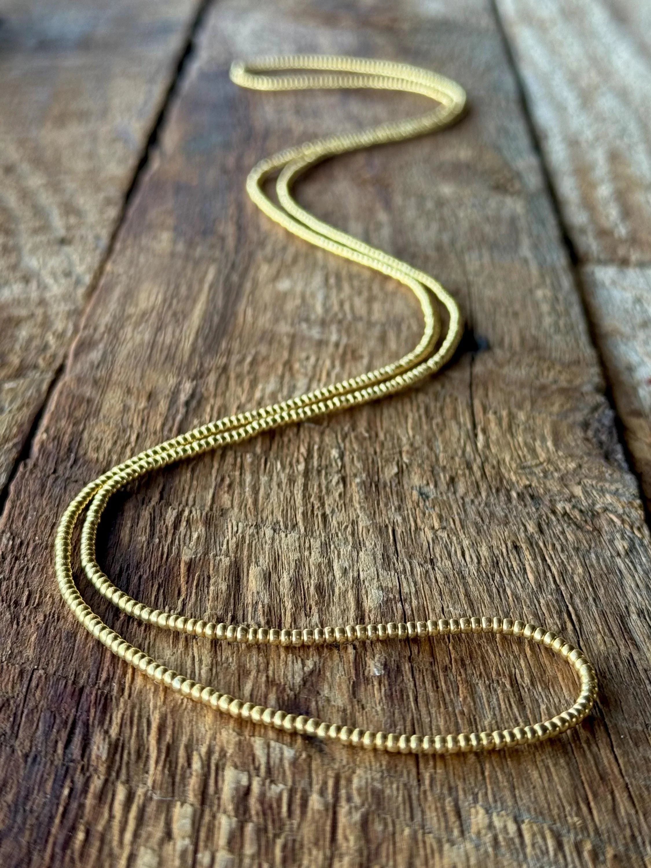 Gold glass seed bead necklace handmade on rustic wood, Seed and Soul artistry jewelry