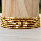 Handmade gold glass seed bead wrap bracelet on wood, Seed and Soul artistry jewelry
