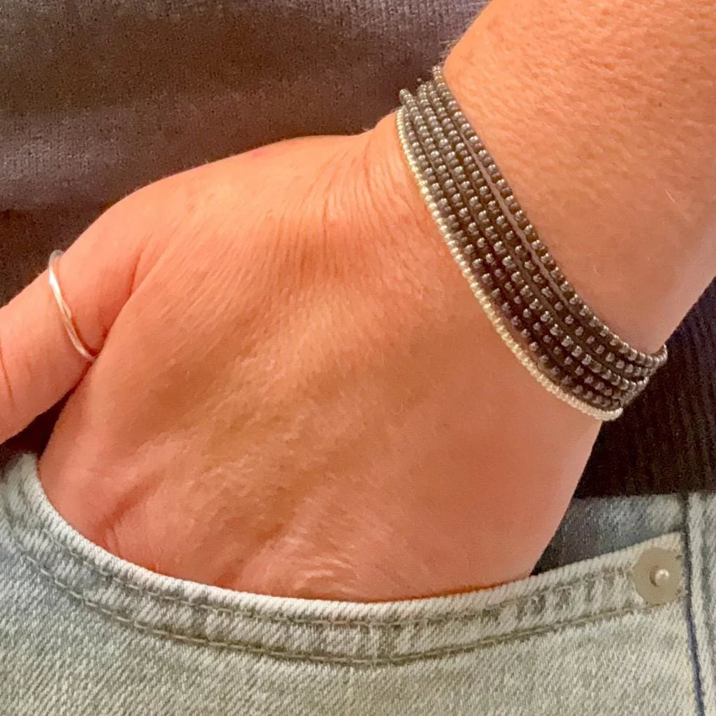 Hand wearing handmade glass seed bead bracelet, Seed and Soul artistry jewelry