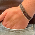Hand wearing handmade glass seed bead bracelet, Seed and Soul artistry jewelry