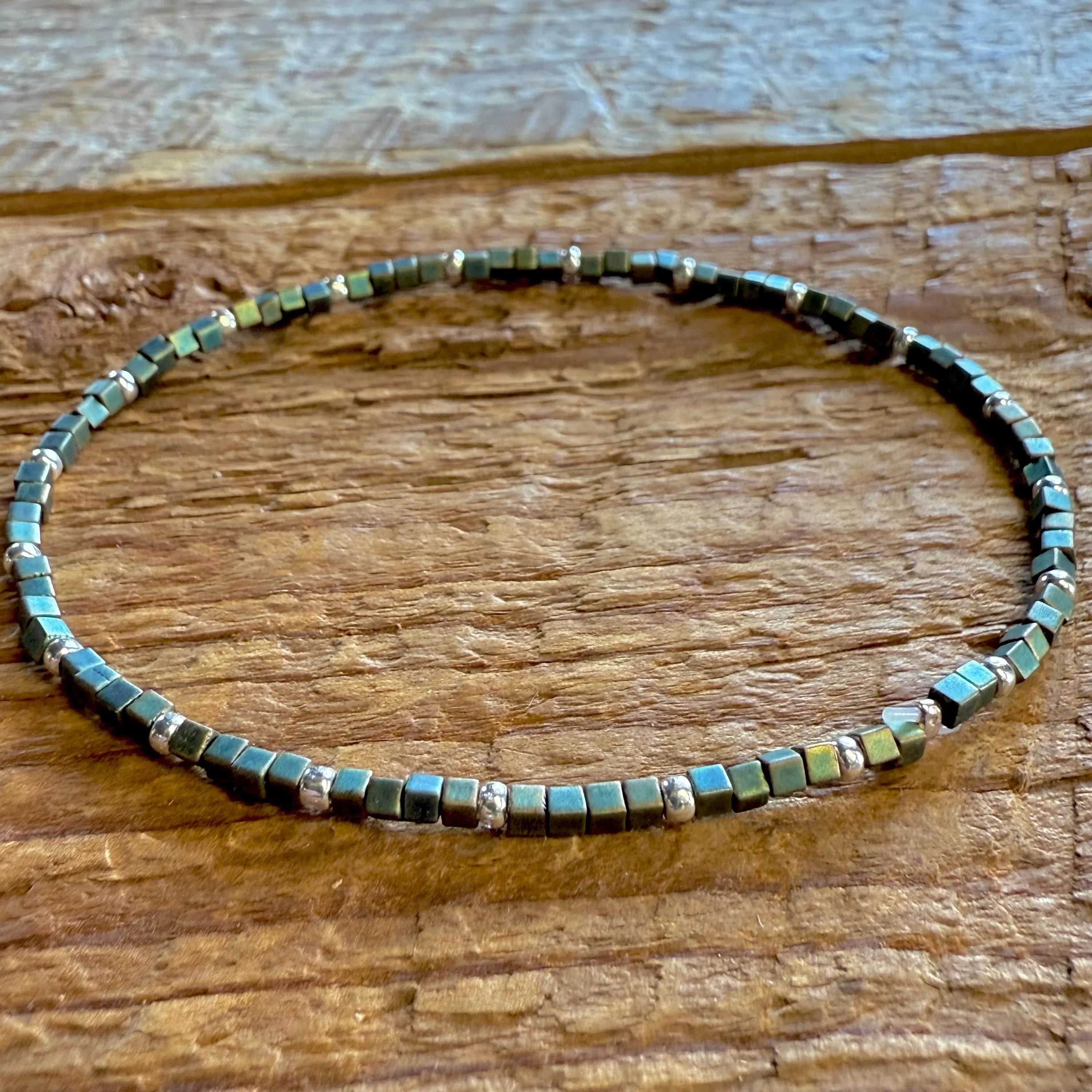 Handmade glass seed bead bracelet with metallic square beads on rustic wood, Seed and Soul artistry