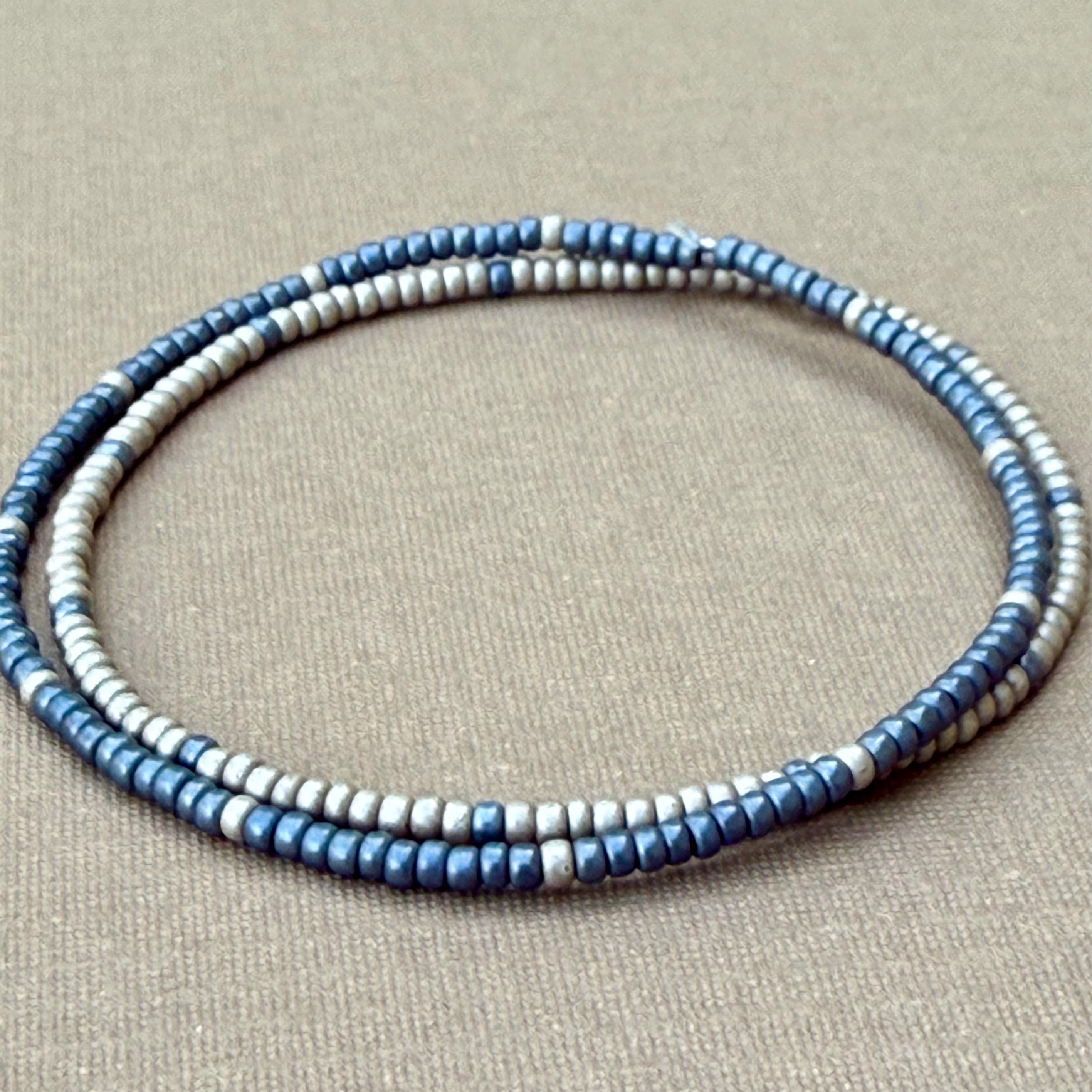 Handmade blue and silver glass seed bead bracelets on beige fabric, Seed and Soul artistry