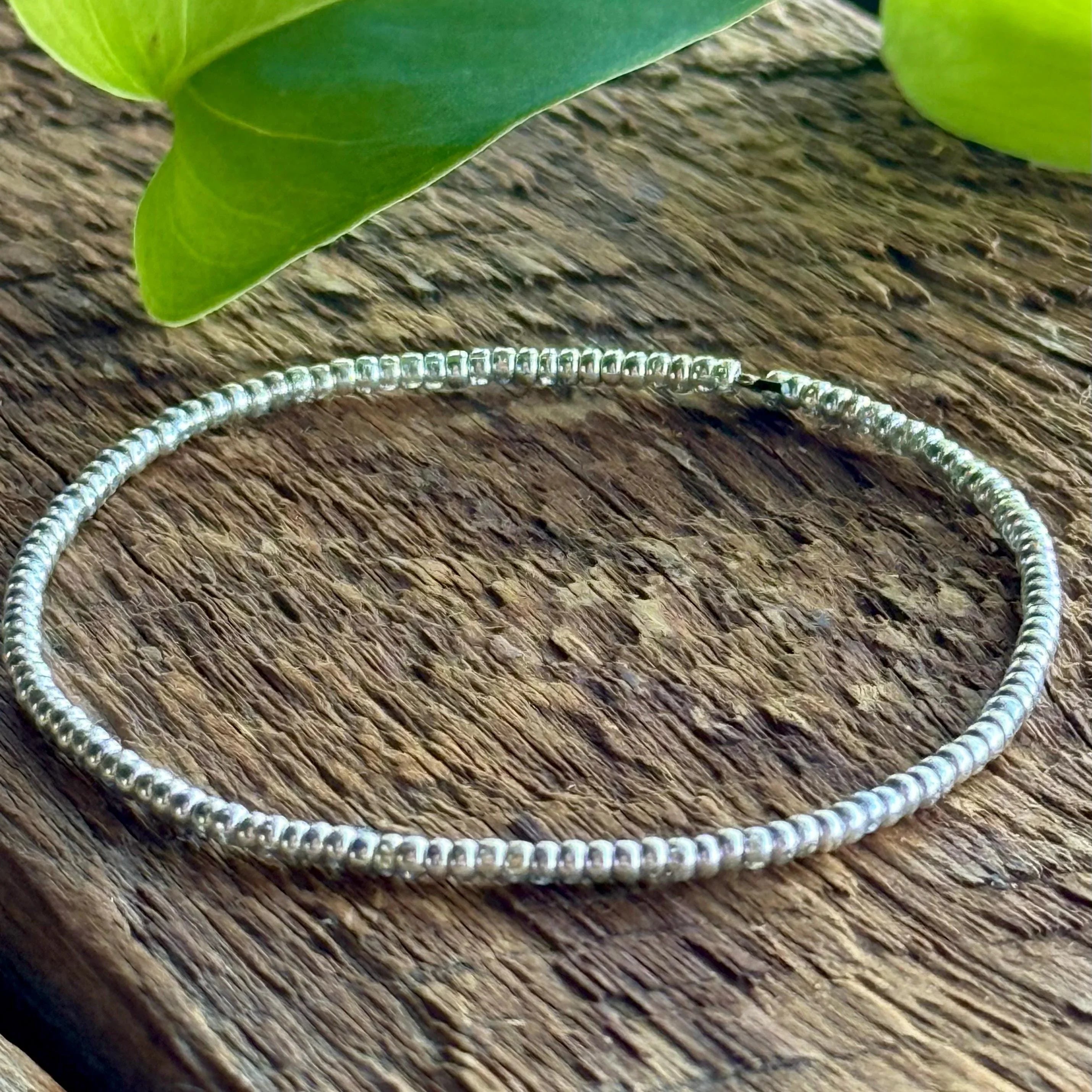 Handmade silver seed bead bracelet on wood, Seed and Soul artistry jewelry