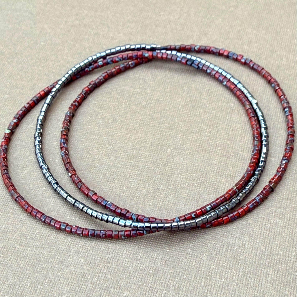 Handmade glass seed bead bracelet in red and metallic tones by Seed and Soul artistry