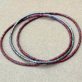 Handmade glass seed bead bracelet in red and metallic tones by Seed and Soul artistry