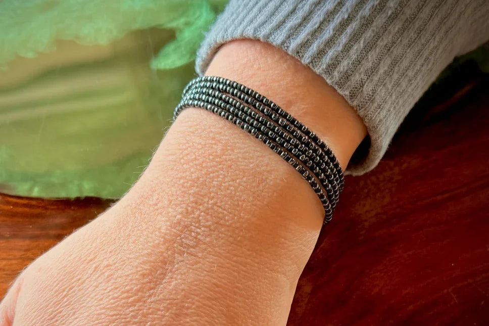 Handmade black glass seed bead bracelet on wrist, Seed and Soul artistry jewelry