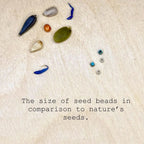 Glass seed beads and natural seeds on wood with comparison text, Seed and Soul artistry jewelry.
