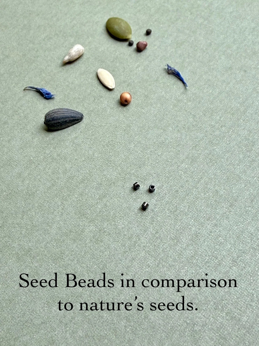 Glass seed beads and natural seeds on textured background, Seed and Soul artistry handmade jewelry