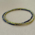 Handmade glass seed bead bracelet set of two in yellow and black on tan background