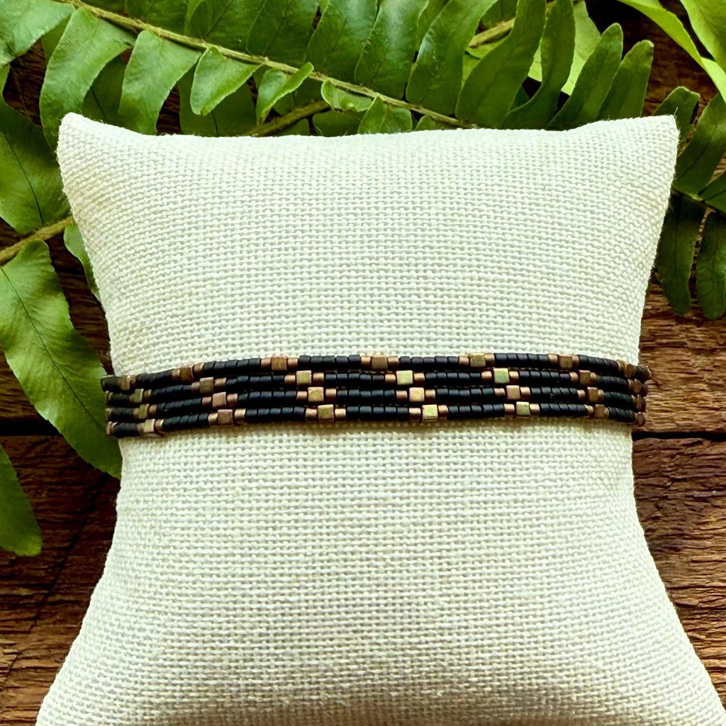 Handmade glass seed bead bracelet in black and bronze on display, Set of 4 bracelets, Seed and Soul artistry jewelry