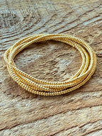 Handmade gold glass seed bead bracelet on rustic wood, Seed and Soul artistry jewelry USA