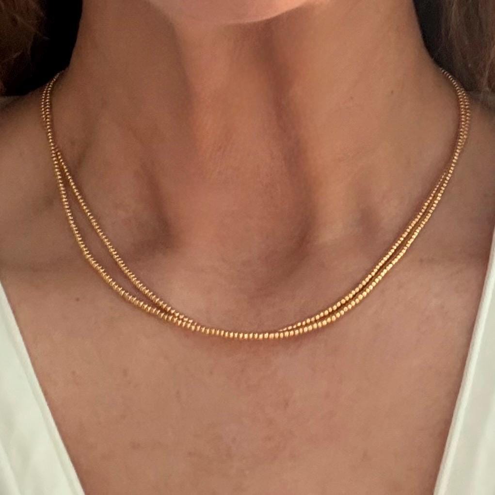 Handmade gold glass seed bead necklace on woman's neck, Seed and Soul artistry jewelry