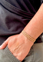 Handmade glass seed bead bracelet in neutral tones on wrist, Seed and Soul artistry jewelry