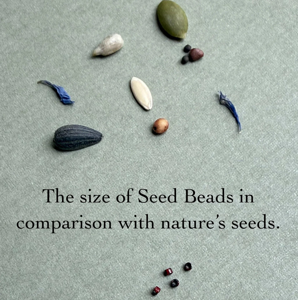 Glass seed beads compared to various natural seeds on a green background, Seed and Soul artistry