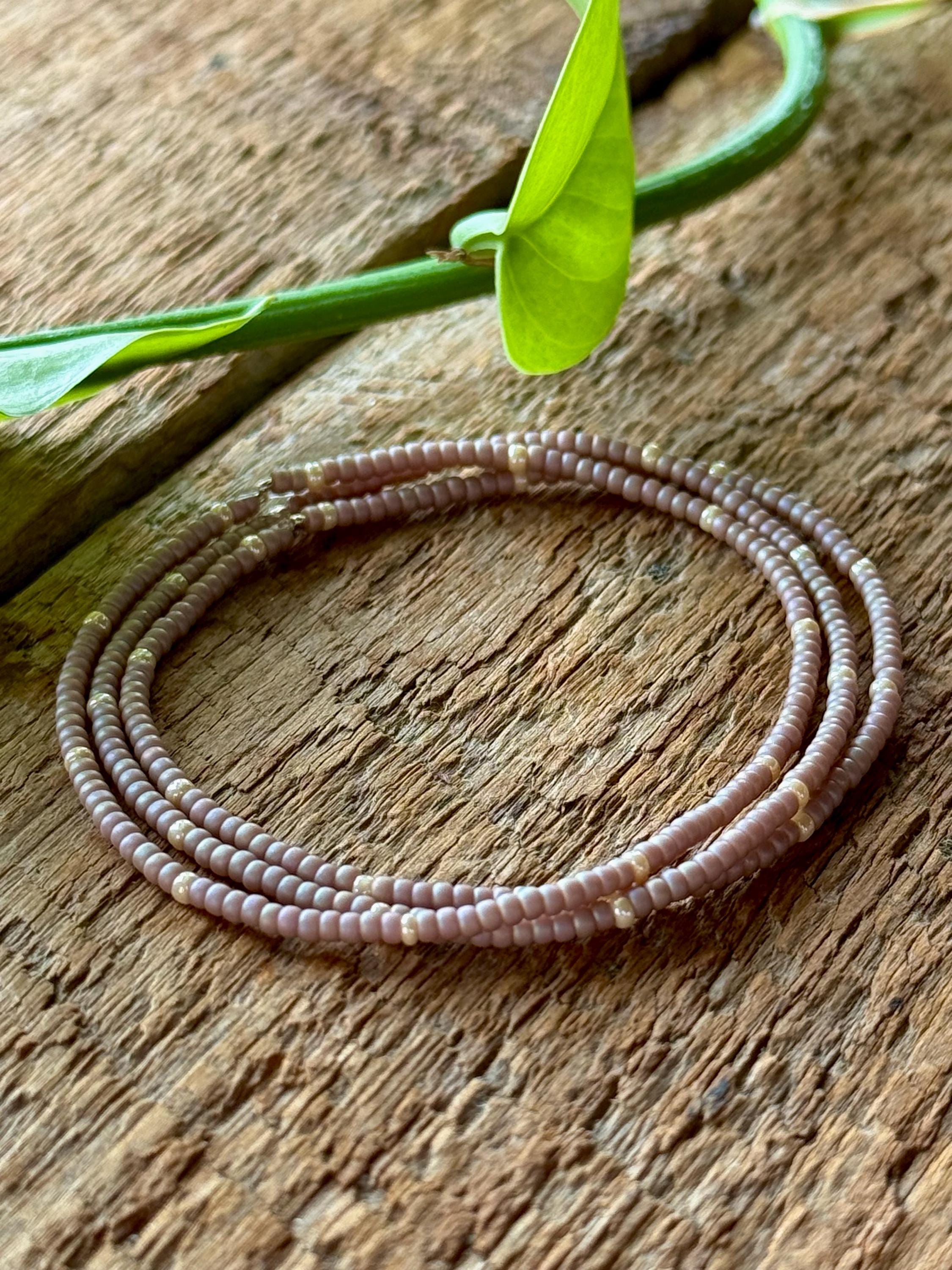 Handmade pink taupe glass seed bead bracelet on rustic wood by Seed and Soul artistry