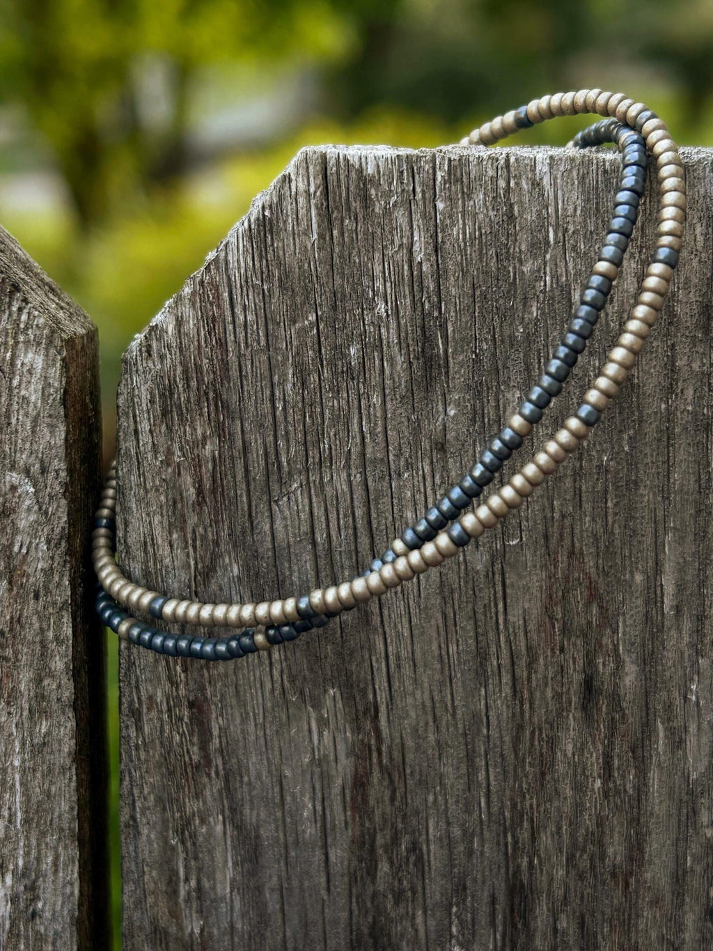 Handmade glass seed bead bracelets in blue and silver by Seed and Soul artistry on weathered wood