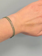 Hand wearing handmade green glass seed bead bracelet by Seed and Soul Artistry