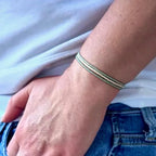 Three stretch seed bead bracelets worn on a writst